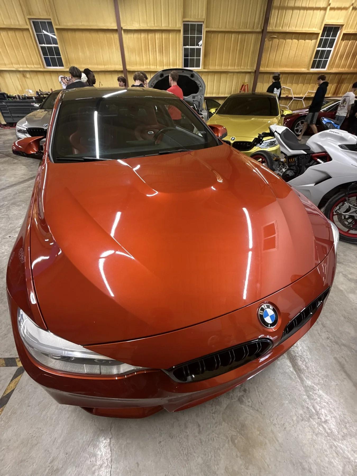Orange BMW front end photographed indoors at a JX Auto Lab detail