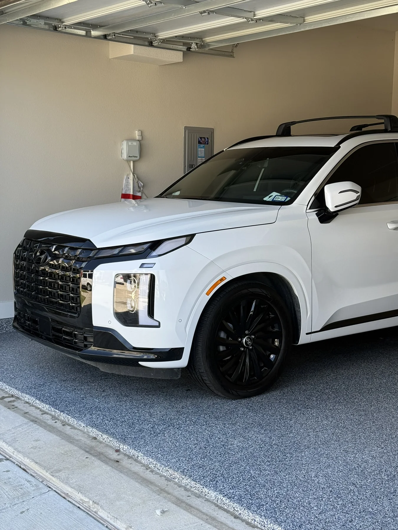 White SUV photographed in a garage at a JX Auto Lab detail